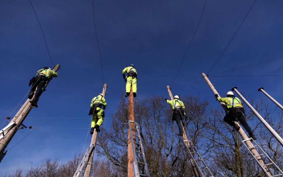 Trainee engineers from BT Openreach, a unit of BT Group Plc, carry out work at the top of telegraph poles at the company's training facility at West Hanningfield, U.K - Chris Ratcliffe/Bloomberg