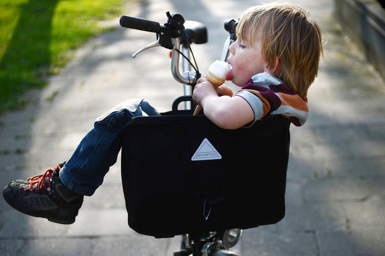 Kid eating ice cream in brompton bag