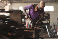 An Indian worker prepares steel furniture at a factory on the outskirts of Jammu, India, Saturday, Sept.26, 2020. Millions of distressed Indian manufacturers and traders are counting on the eagerly-awaited October-December festive season to rescue them from their coronavirus catastrophe. But spending may be the last thing on the minds of many Indians who have lost their jobs or businesses in the pandemic downturn. India's pandemic assistance has amounted to only about 1% of its GDP, Nobel laureate Abhijit Banerjee said, compared with the U.S.'s package in March of about 10% of its GDP. (AP Photo/Channi Anand)