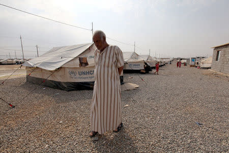 A man, who fled from the Islamic State violence, walks at Debaga Camp in the Makhmour area near Mosul, Iraq, August 30, 2016. REUTERS/Azad Lashkari