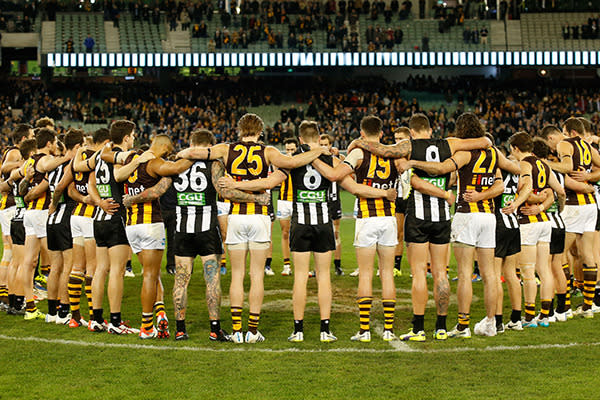 The Hawks and Magpies arm-in-arm in memory of Phil Walsh.