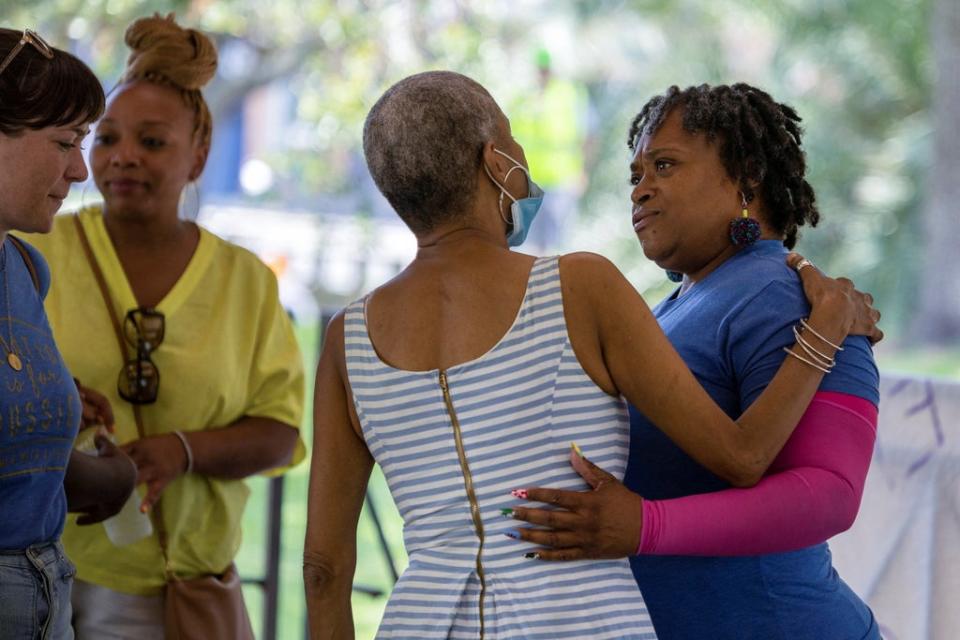 Lift Louisiana statewide outreach coordinator Robin Barber, center, greets Women With a Vision’s Deon Haywood, right, during demonstrations supporting abortion rights in New Orleans on 14 May. (REUTERS)