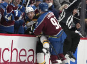 Colorado Avalanche left wing Gabriel Landeskog, front, runs Boston Bruins left wing Taylor Hall into the team box in the second period of an NHL hockey game Wednesday, Jan. 26, 2022, in Denver. (AP Photo/David Zalubowski)