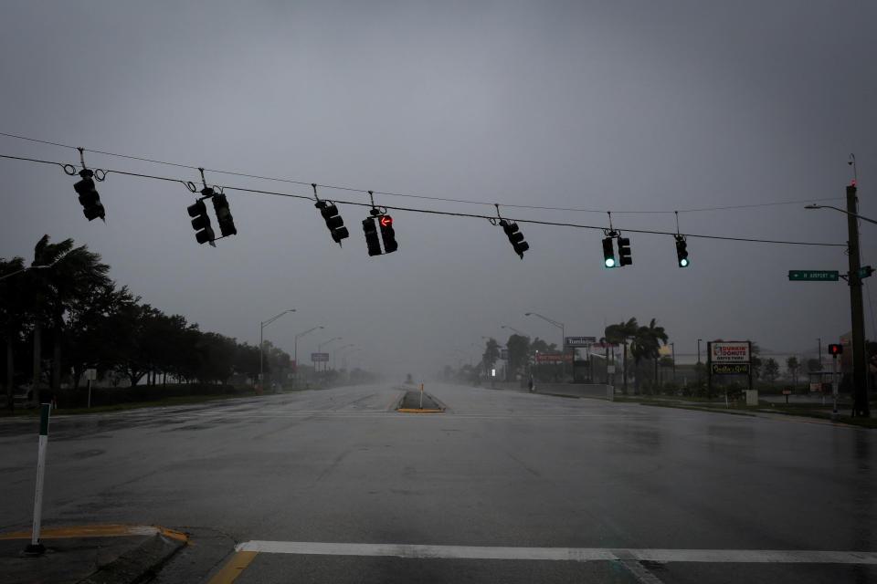 Traffic lights wave by strong gust of wind ahead of Hurricane Ian