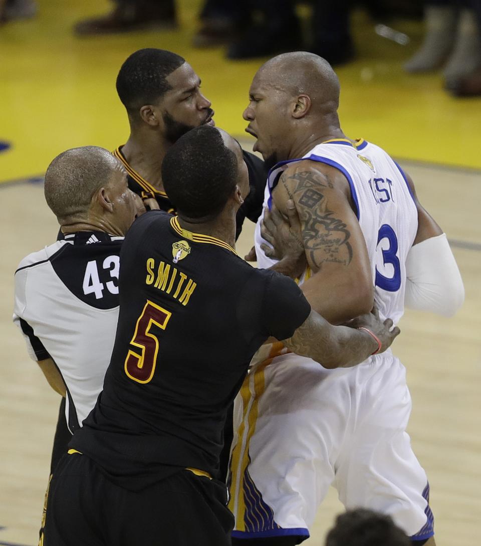 <p>Cleveland Cavaliers center Tristan Thompson, top left, and Golden State Warriors forward David West (3) are separated by guard J.R. Smith (5) and referee Dan Crawford (43) during the first half of Game 5 of basketball’s NBA Finals in Oakland, Calif., Monday, June 12, 2017. (AP Photo/Marcio Jose Sanchez) </p>