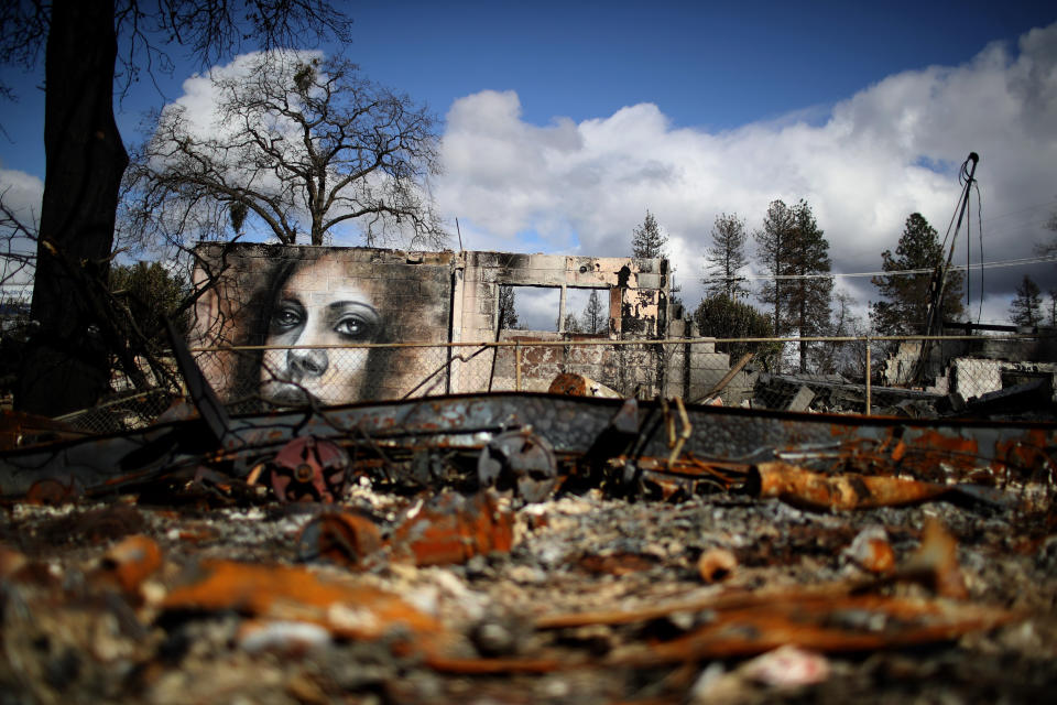 A mural by artist Shane Grammer is visible on the wall of a building destroyed by the 2018 wildfire that destroyed the town of Paradise, California. Climate change is leading to more intense and more frequent wildfires. (Photo: Justin Sullivan via Getty Images)