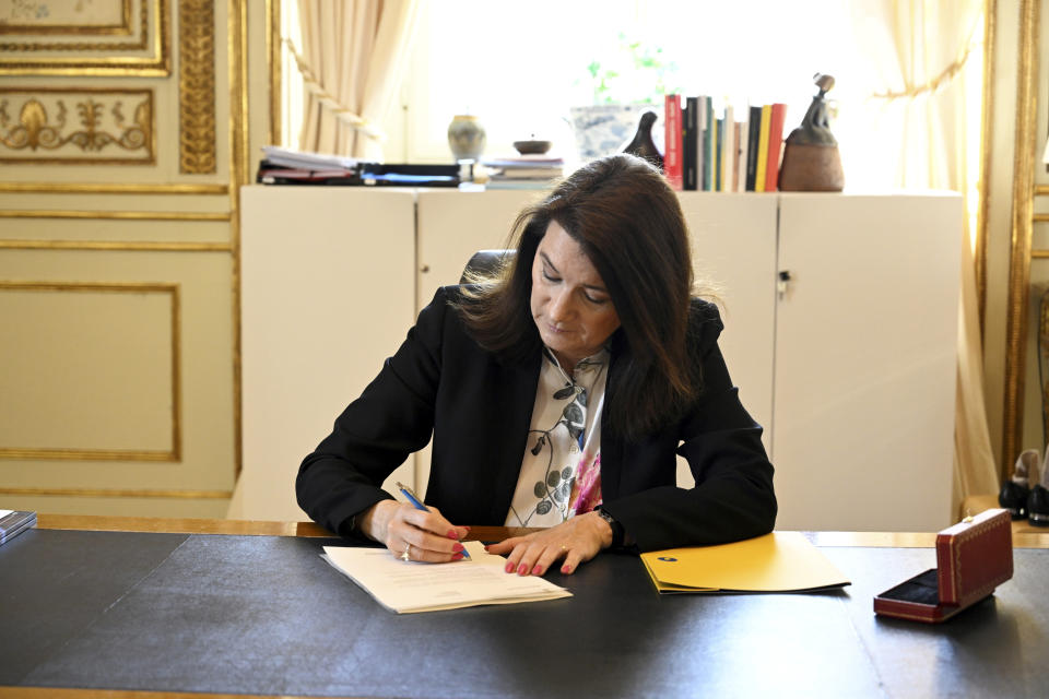 Swedish Minister of Foreígn Affairs Ann Linde signs Sweden's application for NATO membership at the Ministry of Foreign Affairs, in Stockholm, Tuesday, May 17 2022. Sweden's decision to seek NATO membership follows a similar decision by neighboring Finland, a historic shift for the countries, which have been nonaligned for generations. (Henrik Montgomery/TT News Agency via AP)