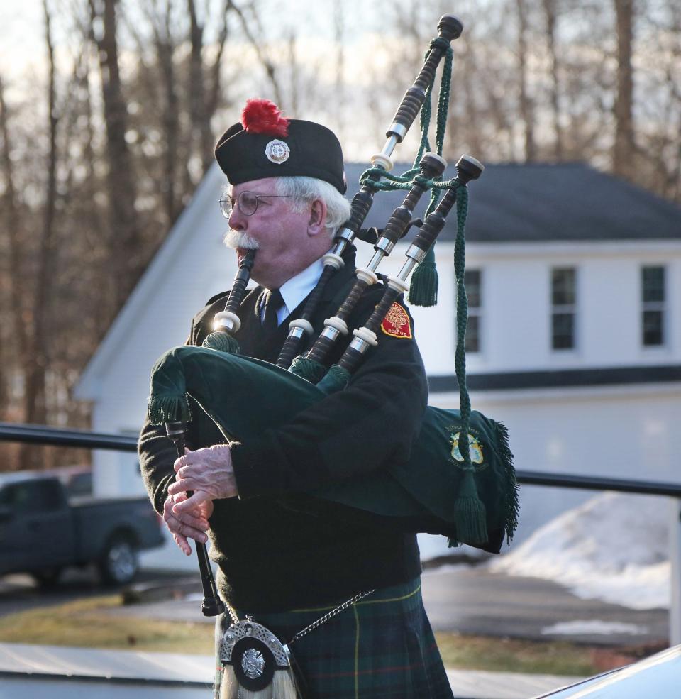 Retired Dover firefighter David McLean plays the bagpipes for his friend and retired Kittery fire chief George Varney Jr.'s funeral in Eliot Jan. 18, 2022.