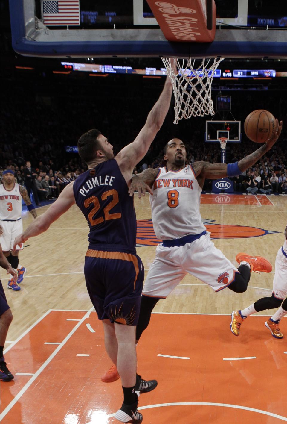 New York Knicks' J.R. Smith (8) drives past Phoenix Suns' Miles Plumlee (22) during the first half of an NBA basketball game, Monday, Jan. 13, 2014, in New York. (AP Photo/Frank Franklin II)