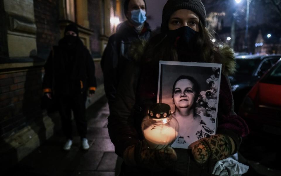 Protesters carry pictures of the woman who died - Omar Marques /Getty Images