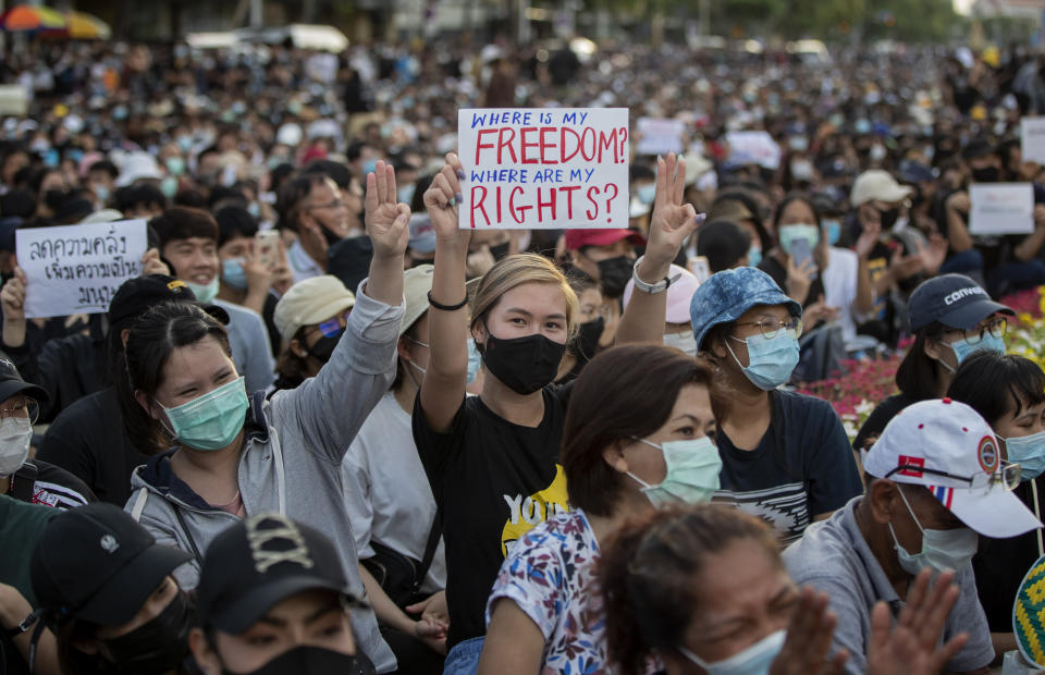 Pro-democracy activities display placards and raise a three-fingers salute, a symbol of resistance during a protest at Democracy Monument in Bangkok, Thailand, Sunday, Aug, 16, 2020. A two-day rally planned for this weekend is jangling nerves in Bangkok, with apprehension about how far student demonstrators will go in pushing demands for reform of Thailand’s monarchy and how the authorities might react. More than 10,000 people are expected to attend the Saturday-Sunday event. (AP Photo/Gemunu Amarasinghe)