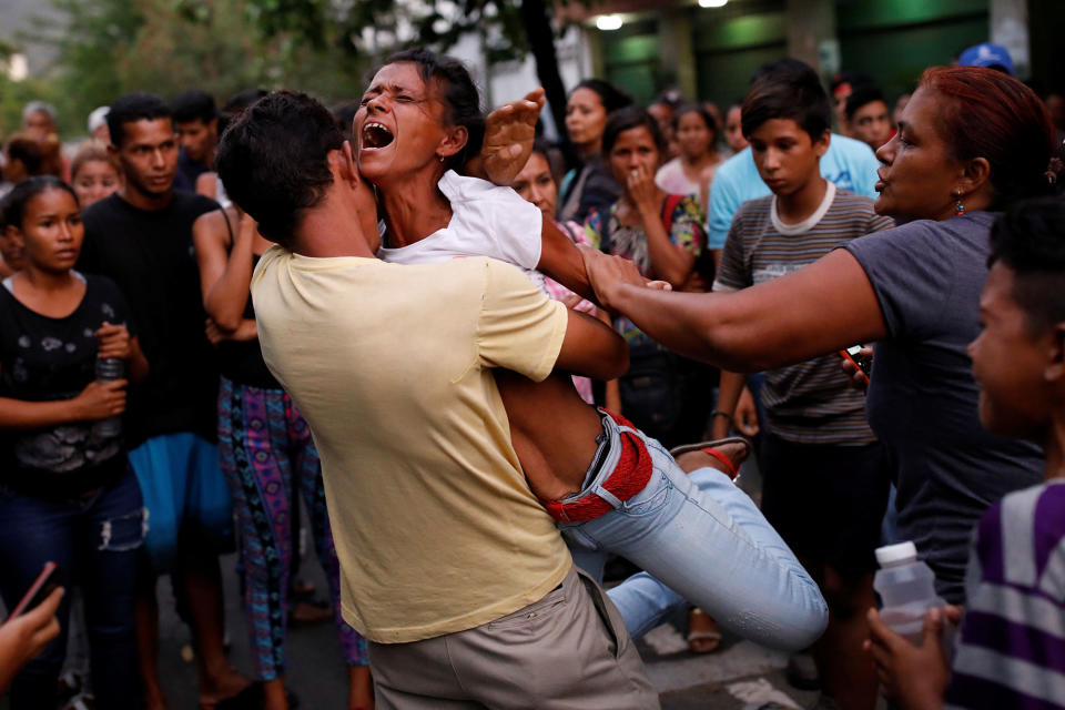 <p>Relatives of inmates held at the General Command of the Carabobo Police react as they wait outside the prison, where a fire occurred in the cells area, according to local media, in Valencia, Venezuela, March 28, 2018. (Photo: Carlos Garcia Rawlins/Reuters) </p>