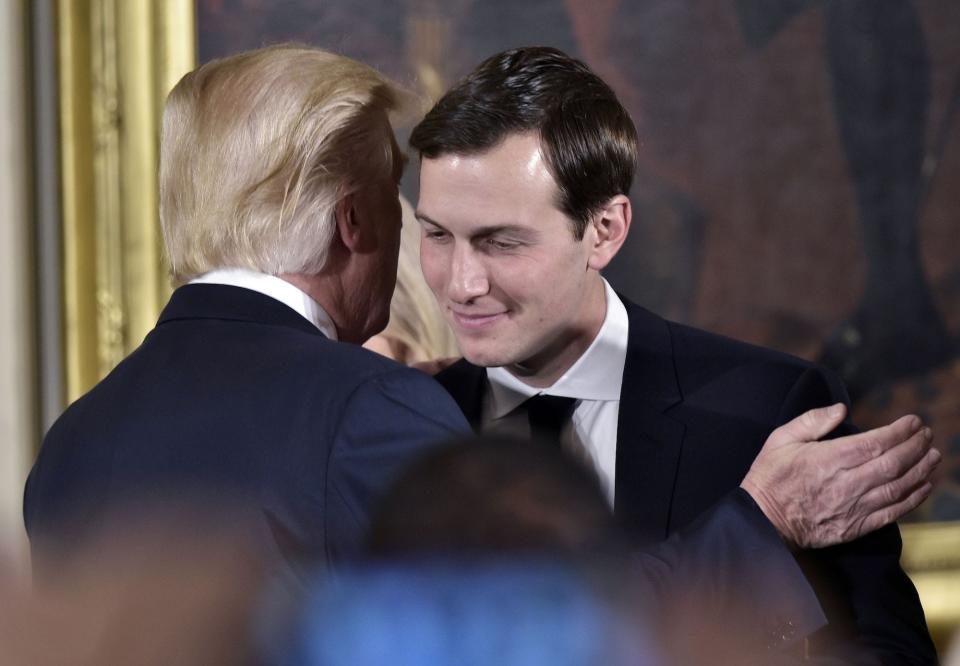 US President Donald Trump (L) congratulates his son-in-law and senior advisor Jared Kushner