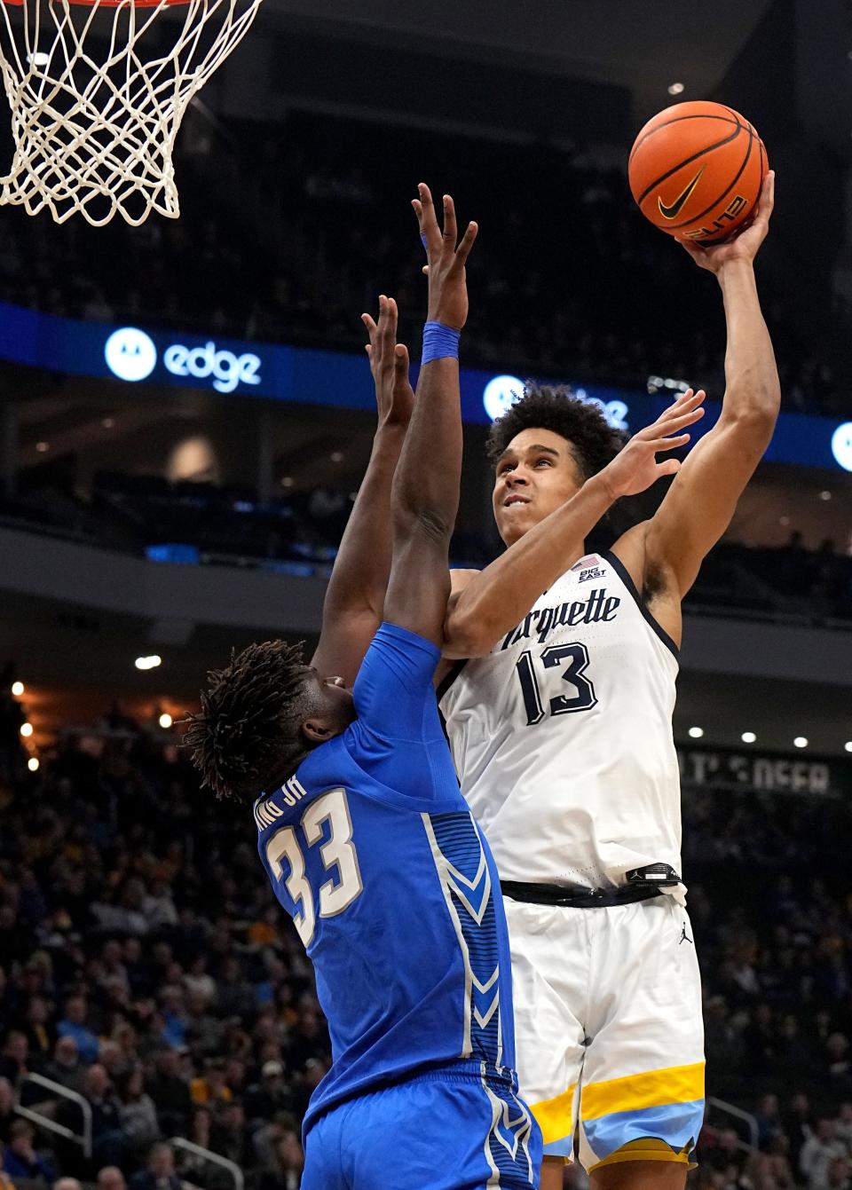 Marquette forward Oso Ighodaro shoots over Creighton center Fredrick King during the first half on Friday Fiserv Forum. Ighodaro had a team-high 16 points in the Golden Eagles' 69-58 victory.