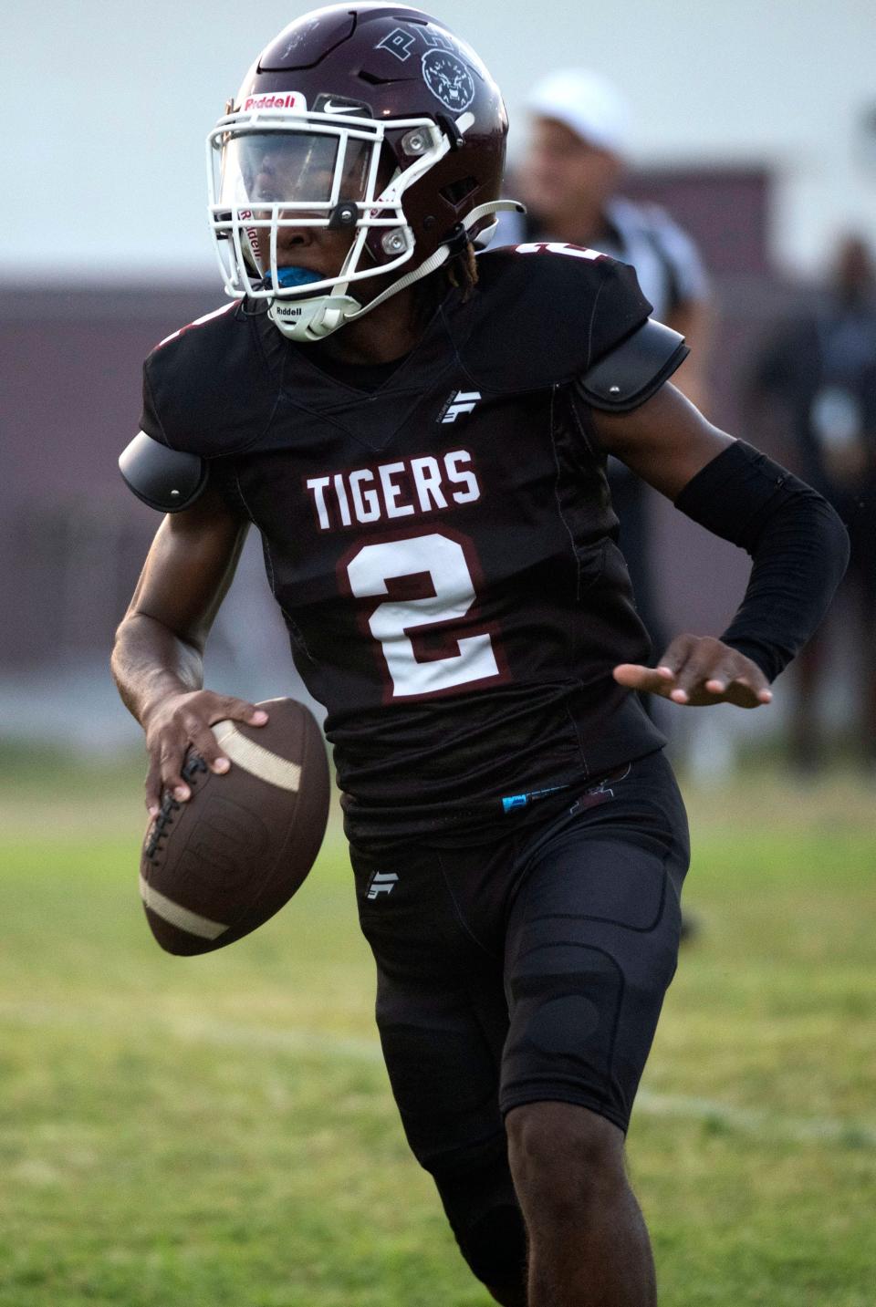 Pensacola High School's Jamarcuz Fountain (No. 2) rolls out of the pocket as he looks for an open receiver during Friday night's home opener against Washington High School.