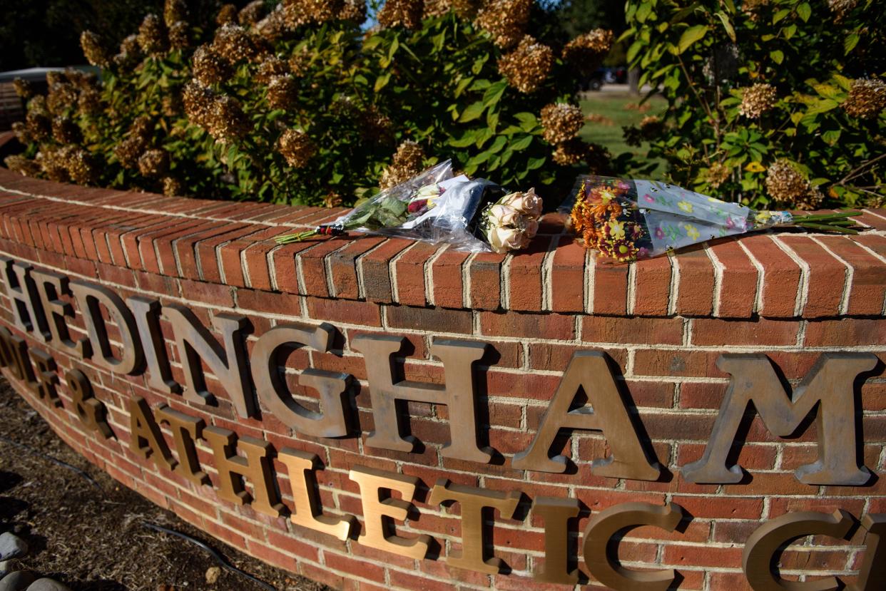 Memorial flowers for 5 victims of a mass shooting lay on an entrance to Hedingham neighborhood on October 14, 2022 in Raleigh, North Carolina. 