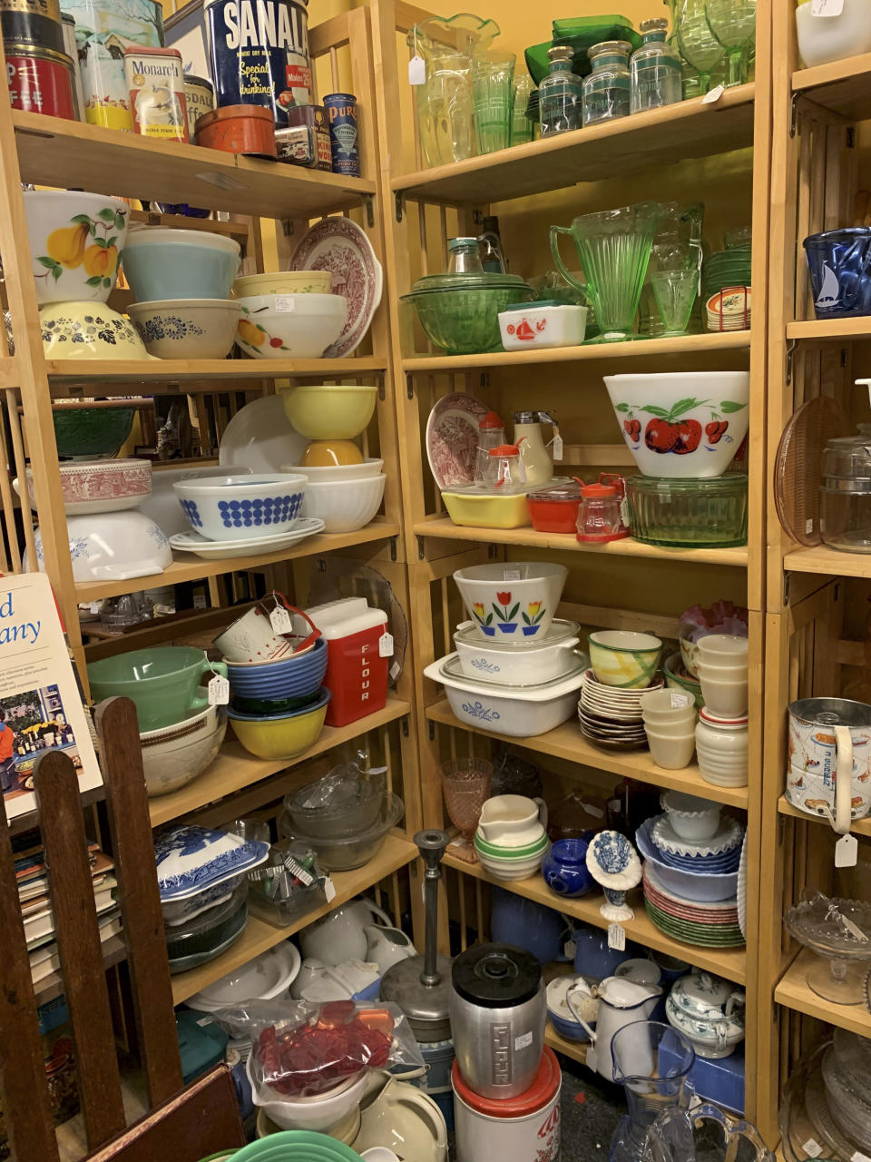 This image provided by Tracee Herbaugh exhibits some of the vintage kitchenware available at a Waltham, Massachusetts antique shop. Television and social media have also generated interest. Series like "WandaVision," "Firefly Lane," "The Marvelous Mrs. Maisel" and "Mad Men" all highlight midcentury kitchens and kitchenware. (Tracee Herbaugh via AP)