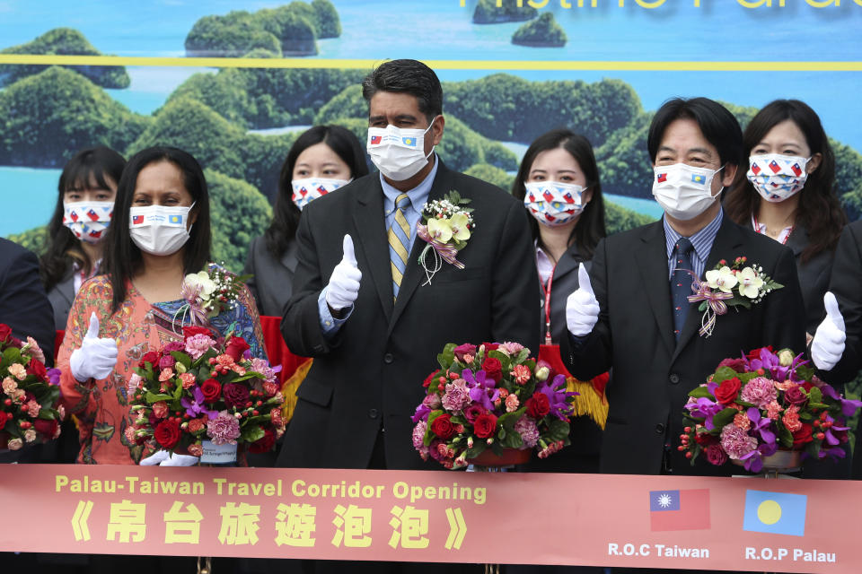 Palau President Surangel Whipps, center, and Taiwan Vice President William Lai, right, attend a ceremony of opening of the Palau-Taiwan Travel Corridor in Taipei, Taiwan, Tuesday, March 30, 2021. The Palau-Taiwan Travel Corridor, which allows people to travel between the islands without a COVID-19 quarantine, will start on April 1. (AP Photo/Chiang Ying-ying)