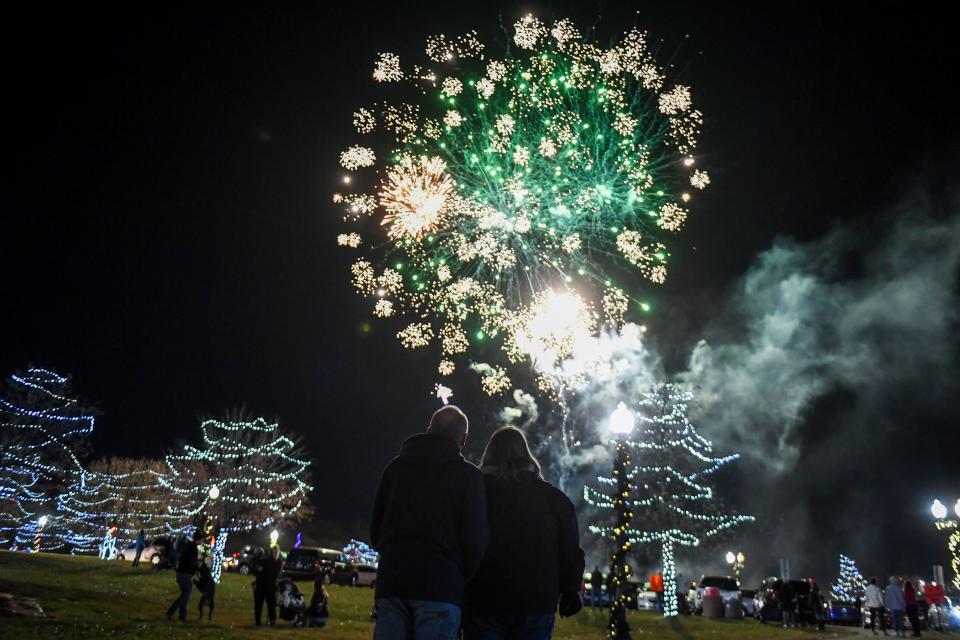 Gary and Shannon Klarenbeek watch the fireworks during the Falls Park holiday light display event on Friday, Nov. 17, 2023 in Sioux Falls.