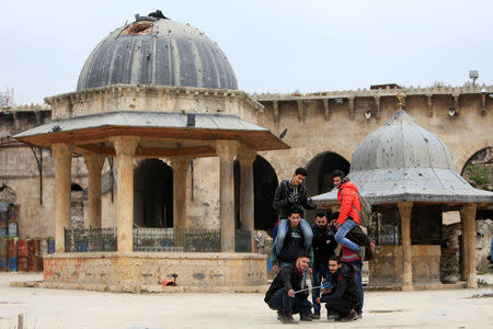 People take a selfie inside Aleppo's Umayyad mosque, Syria January 31, 2017. REUTERS/Ali Hashisho