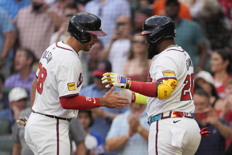Atlanta Braves designated hitter Marcell Ozuna (20) celebrates with Matt Olson (28) after hitting a three-run hom run in the first inning of a baseball game against the Boston Red Sox Wednesday, May 8, 2024, in Atlanta. (AP Photo/John Bazemore)