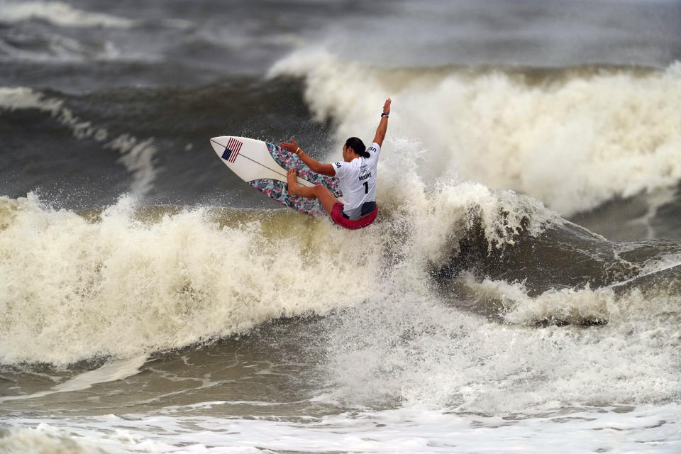 Carissa Moore, of the United States, preforms on the wave during the gold medal heat in the women's surfing competition at the 2020 Summer Olympics, Tuesday, July 27, 2021, at Tsurigasaki beach in Ichinomiya, Japan. (AP Photo/Francisco Seco)