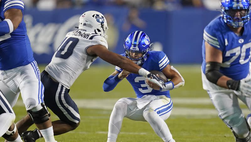 BYU quarterback Jaren Hall (3) is sacked by Utah State linebacker AJ Vongphachanh (10) during the first half of an NCAA college football game Thursday, Sept. 29, 2022, in Provo.