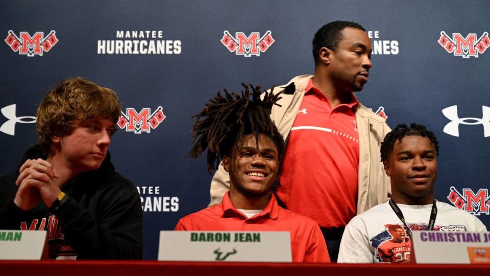 Max Freeman, Daron Jean and Christian Johnson with Coach Jacquez Green at signing day at Manatee High on Wednesday, Feb. 7, 2024.