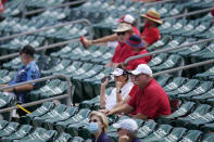 Fans sit in a socially distant pods inside Roger Dean Stadium during a spring training baseball game between the St. Louis Cardinals and Washington Nationals Sunday, Feb. 28, 2021, in Jupiter, Fla. (AP Photo/Jeff Roberson)