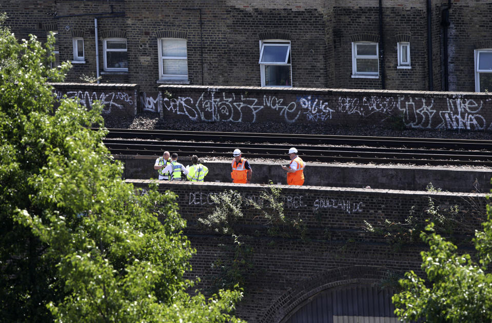 The bodies of the three men were found on a railway track near Loughborough Junction railway station. (Yui Mok/PA via AP)