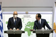 Greek Foreign Minister Nikos Dendias, left, and his Cyprus counterpart Nicos Christodoulides talk to the media during a press conference at the foreign ministry house in divided capital Nicosia, Cyprus, Dec. 4, 2020. Dendias and Christodoulides were meeting to coordinate their course of action ahead of a summit of European Union leaders next week to decide on a Turkish hydrocarbons search in waters where Cyprus and Greece claim exclusive rights and which EU officials have called " provocative"and "unlawful." (AP Photo/Petros Karadjias, Pool)