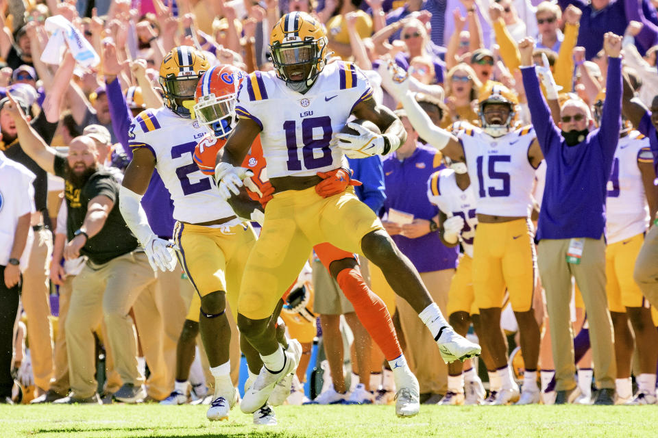 LSU linebacker Damone Clark (18) makes an interception against Florida wide receiver Rick Wells (12) in the second half of an NCAA college football game in Baton Rouge, La., Saturday, Oct. 16, 2021. (AP Photo/Matthew Hinton)