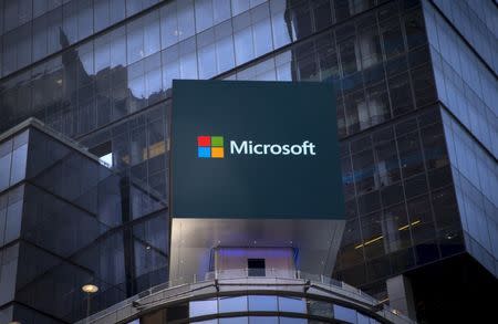 The Microsoft logo is seen on an electronic billboard on an office building in New York City, July 28, 2015. REUTERS/Mike Segar