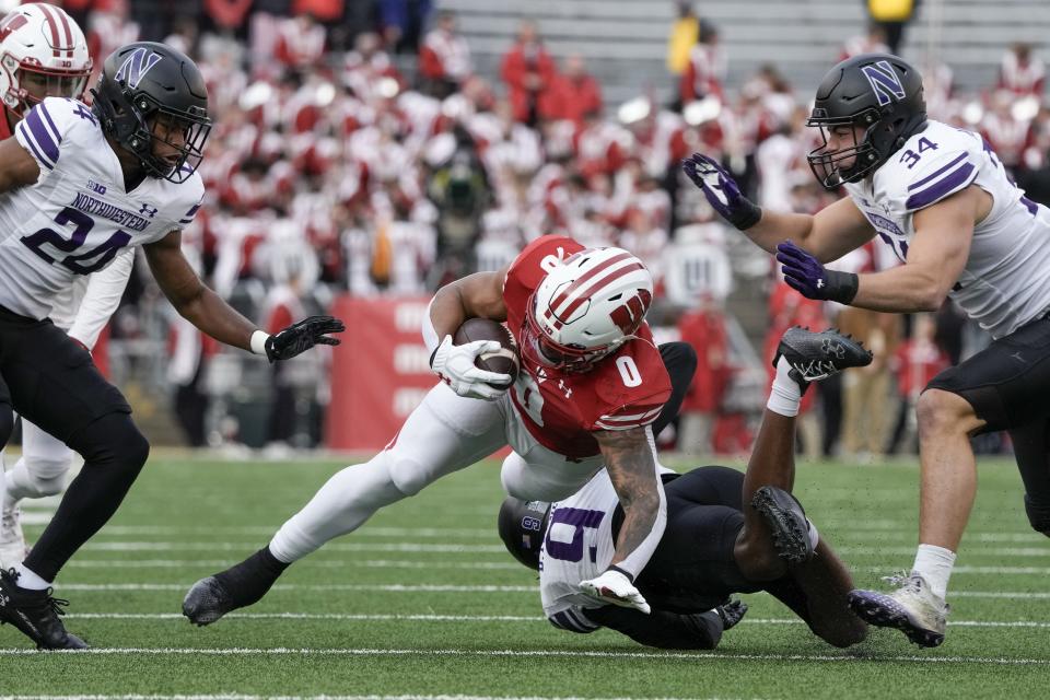 Wisconsin's Braelon Allen (0) is stopped during the first half of an NCAA college football game against Northwestern Saturday, Nov. 11, 2023, in Madison, Wis. (AP Photo/Morry Gash)