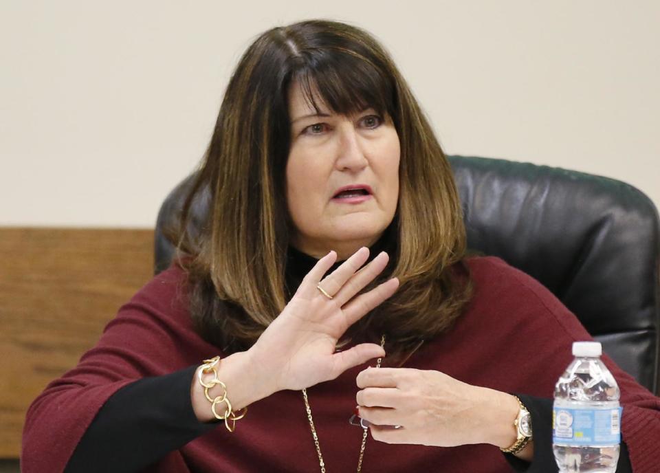 Martha A. Burger, president of the Oklahoma State Board of Health, gestures as she speaks during a meeting in Oklahoma City, Tuesday, Dec. 13, 2016. Oklahoma plans to force hospitals, nursing homes, restaurants and public schools to post signs inside public restrooms directing pregnant women where to receive services as part of an effort to reduce abortions in the state. (AP Photo/Sue Ogrocki)