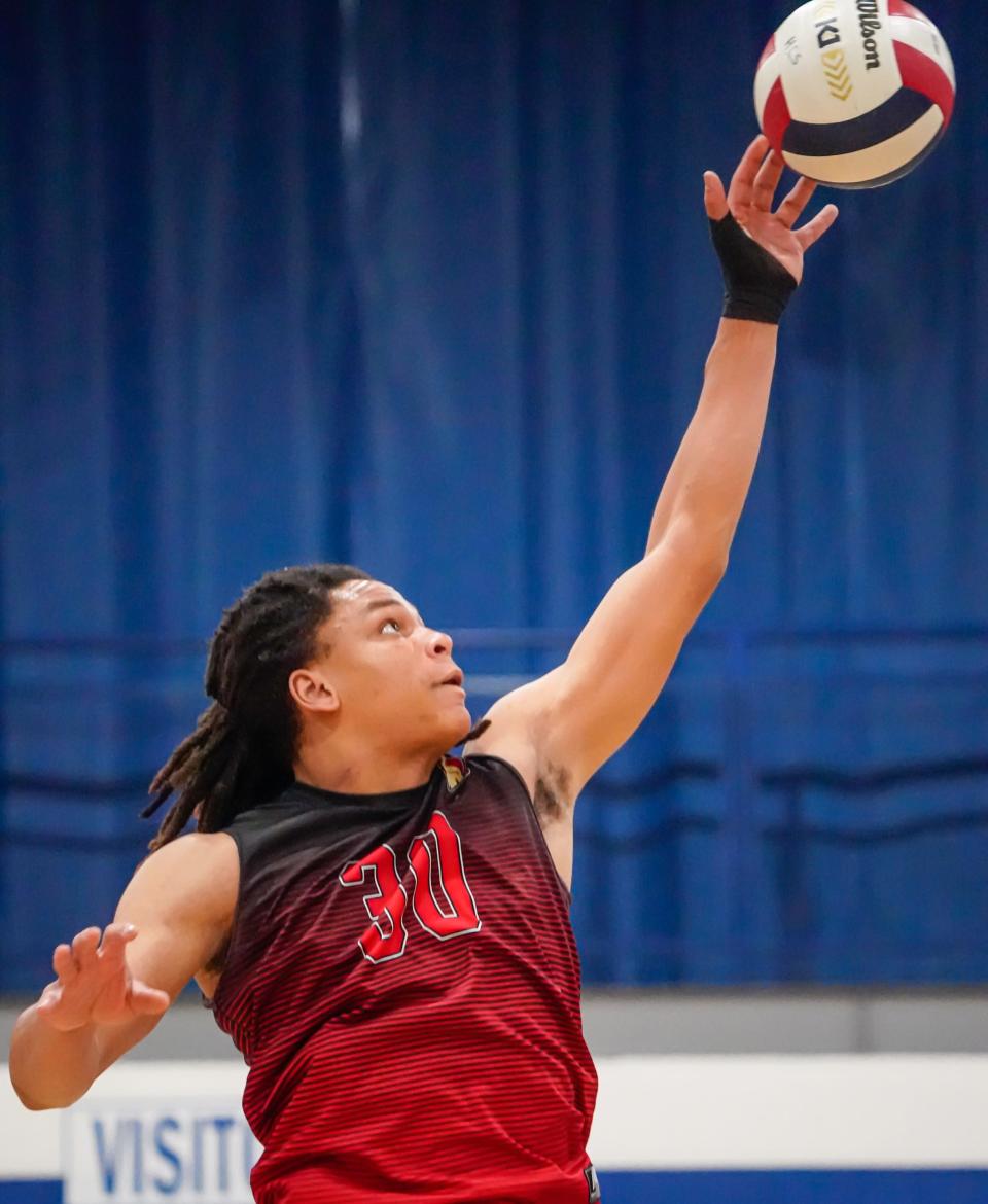 Herron High School boys varsity volleyball player Gideon Nelson (30) tips the ball during a game between Herron High School Achaeans and Heritage Christian High School Eagles on Tuesday, May 7, 2024, at H.C.H.S. in Indianapolis.