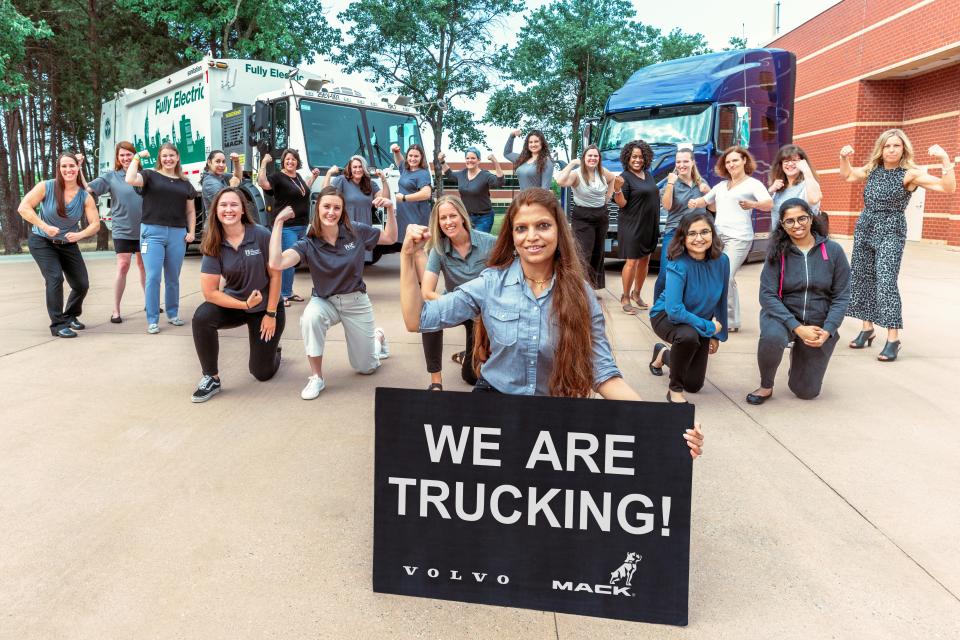 The women in the technical and training teams at Volvo Group North America flex their muscles.