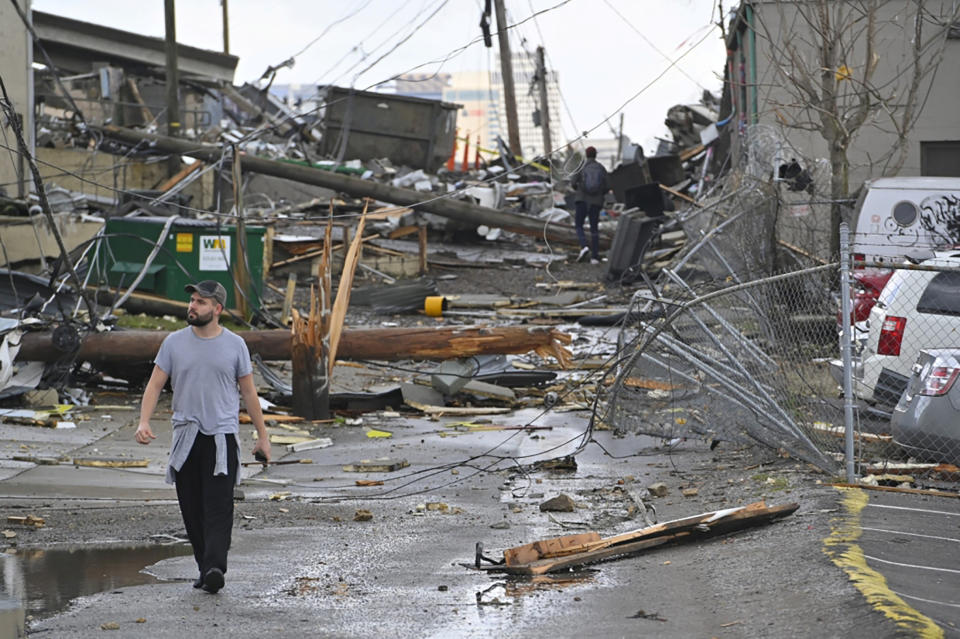 A man views damage in an alley behind Woodland Street after a tornado touched down in Nashville, Tennessee, U.S. March 3, 2020. (REUTERS/Harrison McClary)