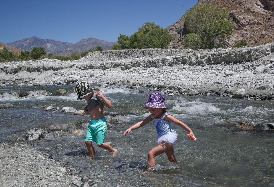 Yolenny, right, and Bentley Lacey play in the Whitewater River in the Whitewater Preserve on Monday under the watchful eye of their parents Kyle and Veronica Lacey of Desert Hot Springs.