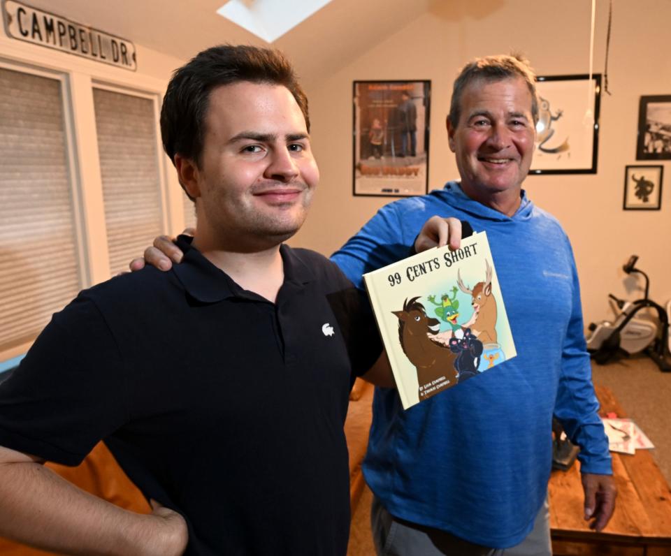 Liam Campbell , who is autistic, with his dad, Tom in their Chatham home Tuesday where he and his father have created this children's book.