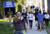 Writers Guild of America member Bart Gold walks with striking actors on a post apocalyptic-themed picket line outside Netflix studios, Wednesday, Nov. 8, 2023, in Los Angeles. (AP Photo/Chris Pizzello)