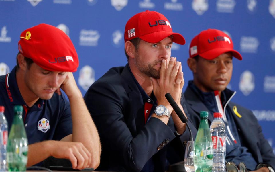 US players Bryson Dechambeau, left, Webb Simpson, center, and Tiger Woods attend the press conference - AP