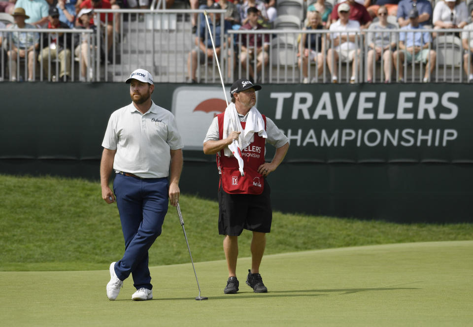 Zack Sucher, left, waits with his caddie Craig Mullinax on the ninth green during the third round of the Travelers Championship golf tournament, Saturday, June 22, 2019, in Cromwell, Conn. (AP Photo/Jessica Hill)
