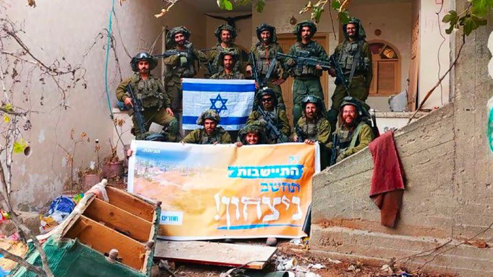 A photograph shows soldiers posing with an orange banner that reads: “Only settlement would be considered victory!” The color orange was used by the settler movement in 2004 and 2005 to protest Israel’s disengagement from Gaza. - Social Media