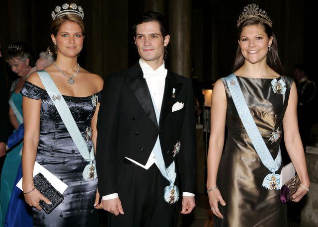 <p>Julian Parker/UK Press via Getty </p> Princess Madeleine, Prince Carl Philip and Crown Princess Victoria at a 2005 gala for Nobel Laureates