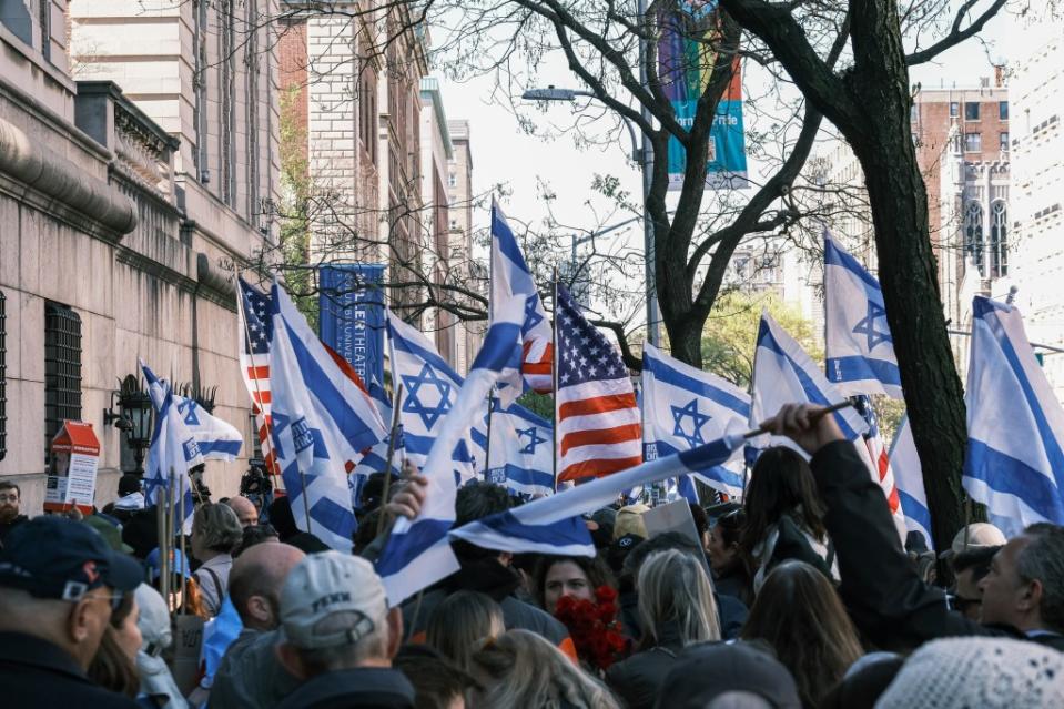 Pro-Israel supporters waving American and Israeli flags outside Columbia’s campus.