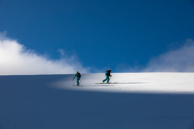 After a long day in the Bayo backcountry, Molly and Brigid make their way home on the edge of sunshine.<p>Photo: Ryan Salm</p>