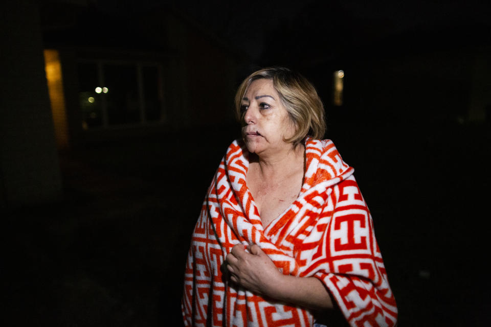 Maria Olivo, a west Houston resident, is shown after a massive explosion blew the window in the room she was sleeping in on Friday, Jan. 24, 2020, in Houston. A massive explosion early Friday leveled a warehouse in Houston and damaged nearby buildings and homes, rousing frightened people from their sleep miles away. (Marie D. De Jesús/Houston Chronicle via AP)