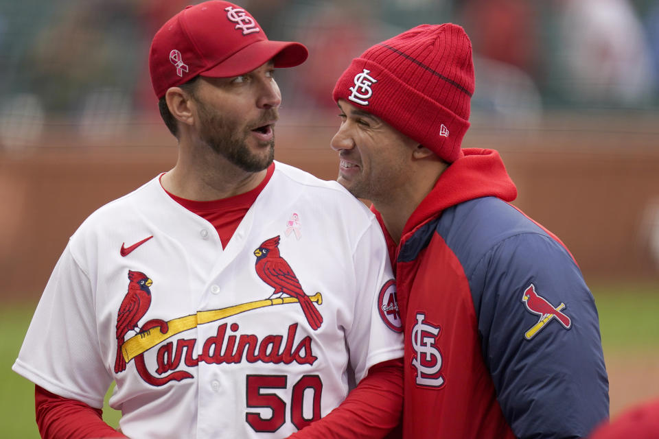 St. Louis Cardinals starting pitcher Adam Wainwright (50) celebrates with teammate Jack Flaherty following a 2-0 victory over the Colorado Rockies in a baseball game Sunday, May 9, 2021, in St. Louis. (AP Photo/Jeff Roberson)
