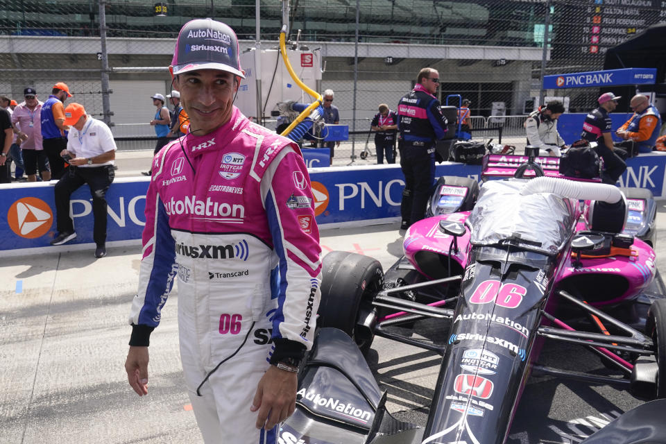 Helio Castroneves, of Brazil, waits in the pits before a IndyCar auto race at Indianapolis Motor Speedway, Saturday, July 30, 2022, in Indianapolis. (AP Photo/Darron Cummings)